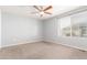 Comfortable bedroom with soft carpet, ceiling fan, and a bright window at 18639 E 50Th Pl, Denver, CO 80249