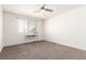 Bright, carpeted bedroom with ceiling fan and natural light from the window at 18639 E 50Th Pl, Denver, CO 80249