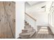 Entryway with wooden barn door, staircase, and hardwood floors at 18639 E 50Th Pl, Denver, CO 80249