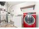 Well-equipped laundry room featuring a modern washer and dryer and a water heater at 18639 E 50Th Pl, Denver, CO 80249
