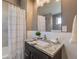 Clean bathroom with granite vanity and updated shower at 3880 Sheridan Blvd, Denver, CO 80212