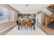 Open concept dining room featuring a six-chair table and kitchen view at 3880 Sheridan Blvd, Denver, CO 80212