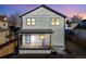 Two-story modern farmhouse with gray siding, blue door and deck at 3880 Sheridan Blvd, Denver, CO 80212