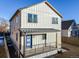 Modern farmhouse exterior, featuring gray siding and a blue door at 3880 Sheridan Blvd, Denver, CO 80212