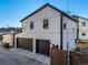 Home's exterior boasts a modern design with two-car garage at 3880 Sheridan Blvd, Denver, CO 80212