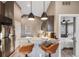 Eat-in kitchen with breakfast bar and pendant lighting at 3880 Sheridan Blvd, Denver, CO 80212