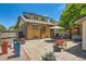 Backyard of a brick home featuring a patio seating area, grill, and mature trees at 4545 King St, Denver, CO 80211