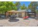 A patio featuring a dining set, lounge chair, hot tub, and a custom-built pergola at 4545 King St, Denver, CO 80211