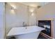 Bright bathroom features a modern tub next to a fireplace and tiled walls at 4545 King St, Denver, CO 80211