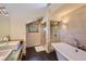 Bright bathroom features a free standing tub and glass-enclosed shower at 4545 King St, Denver, CO 80211