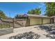 A yellow three-door garage surrounded by a privacy fence at 4545 King St, Denver, CO 80211