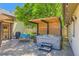 Backyard patio featuring a wooden pergola above a hot tub, grill, and lounge area at 4545 King St, Denver, CO 80211