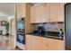 Well-appointed kitchen featuring stainless steel appliances, granite countertops, and light wood cabinetry at 4545 King St, Denver, CO 80211