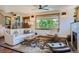 Inviting living room with a ceiling fan, large picture window, and comfortable furniture with a fireplace at 4545 King St, Denver, CO 80211