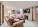 Comfortable living room with a leather sofa, arm chair, and a flat screen television at 4545 King St, Denver, CO 80211