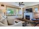 Cozy living room featuring a fireplace, large window with neighborhood views, and comfortable seating at 4545 King St, Denver, CO 80211