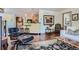 Open concept living space with bar seating, hardwood floors, and cozy sitting area with modern furniture at 4545 King St, Denver, CO 80211