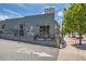 Exterior view of Tocabe restaurant with patio and street parking, mural on exterior at 4545 King St, Denver, CO 80211