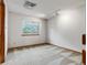 Bright bedroom with neutral carpet, track lighting, and a large window offering ample natural light at 2040 Yarrow St, Lakewood, CO 80214