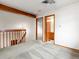 Upstairs hallway with wooden banister and beams and access to the rooms at 2040 Yarrow St, Lakewood, CO 80214
