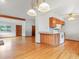 Open-concept living area featuring hardwood floors, wooden beam, and an eat-in kitchen at 2040 Yarrow St, Lakewood, CO 80214