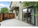 View of the outdoor deck featuring a wood fence and sliding glass doors leading inside at 2077 S Clayton St, Denver, CO 80210