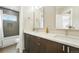 Bathroom featuring a double vanity, modern fixtures, and tile shower with glass door at 2077 S Clayton St, Denver, CO 80210