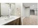 Bathroom featuring a modern vanity with quartz countertop, mirror, and lighting fixtures at 2077 S Clayton St, Denver, CO 80210