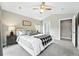 Comfortable bedroom with plush carpeting, a ceiling fan, and ample natural light at 2077 S Clayton St, Denver, CO 80210