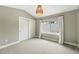 Neutral bedroom features a window, closet, and contemporary light fixture at 2077 S Clayton St, Denver, CO 80210