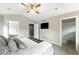 Spacious bedroom featuring a ceiling fan, plush carpeting, and ensuite bath and walk-in closet at 2077 S Clayton St, Denver, CO 80210