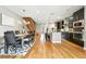 Bright dining room with a wood table, hardwood floors, and a view of the open staircase and kitchen at 2077 S Clayton St, Denver, CO 80210