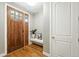 Inviting entryway with a wood door with glass, hardwood floors, a built-in bench, and a coat closet at 2077 S Clayton St, Denver, CO 80210