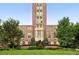 Brick university building with green lawn and trees in an urban setting at 2077 S Clayton St, Denver, CO 80210