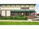 Exterior shot of Bruegger's Bagels with green awnings and red brick details at 2077 S Clayton St, Denver, CO 80210