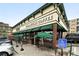 Exterior of Starbucks with outdoor seating area, green awnings and red brick accents at 2077 S Clayton St, Denver, CO 80210