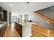 Bright, open kitchen boasts an island with granite counters and a view into the adjacent living and dining spaces at 2077 S Clayton St, Denver, CO 80210