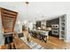 Spacious kitchen with modern appliances, granite countertops, a large island, and a view of the dining room at 2077 S Clayton St, Denver, CO 80210