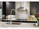 Close-up of a kitchen showcasing granite countertops, stainless steel appliances, and modern backsplash at 2077 S Clayton St, Denver, CO 80210