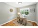 Bright home office featuring a modern desk, hardwood floors, and a window with a view of the outdoors at 2077 S Clayton St, Denver, CO 80210