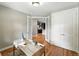 Office featuring hardwood floors and a view to the kitchen through glass french doors at 2077 S Clayton St, Denver, CO 80210