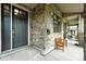 Covered front porch with stone accents, a bench, and plenty of room to relax and enjoy the outdoors at 2077 S Clayton St, Denver, CO 80210