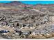 Stunning aerial view of a neighborhood nestled among rolling hills and expansive mountain views at 15798 Weaver Gulch Dr, Morrison, CO 80465