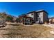Spacious backyard featuring an outdoor seating area under a pergola, as well as a hot tub at 15798 Weaver Gulch Dr, Morrison, CO 80465