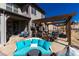 Spacious patio features comfortable couches, a grill and covered dining, perfect for relaxation and entertainment at 15798 Weaver Gulch Dr, Morrison, CO 80465