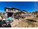 Expansive backyard with a cozy outdoor seating and dining area under a pergola and a stone paved patio at 15798 Weaver Gulch Dr, Morrison, CO 80465