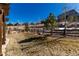 A view of the spacious backyard with a wooden fence that borders the back of the property at 15798 Weaver Gulch Dr, Morrison, CO 80465