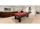 Finished basement offers a pool table, a comfortable leather couch and a flat-screen tv at 15798 Weaver Gulch Dr, Morrison, CO 80465