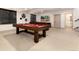 Finished basement offers a pool table, a comfortable leather couch and a flat-screen tv at 15798 Weaver Gulch Dr, Morrison, CO 80465