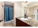 Bathroom features a granite countertop, modern lighting, and a view into the shower/toilet area at 15798 Weaver Gulch Dr, Morrison, CO 80465